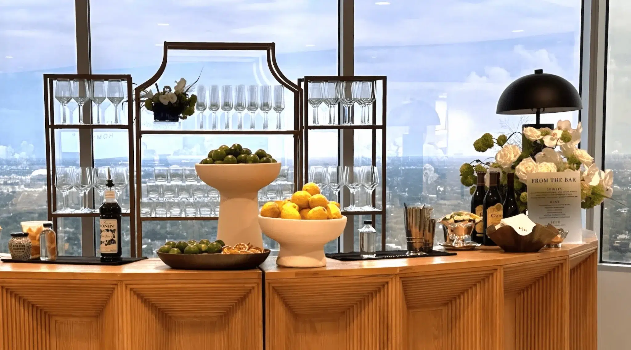 Decorative bar setup with glasses, fruits, and a menu