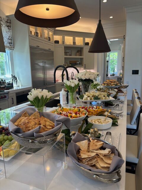A beautifully arranged buffet spread featuring various food items in a modern kitchen